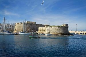 a boat in a body of water with a castle at Holiday Home Fontana Greca in Gallipoli