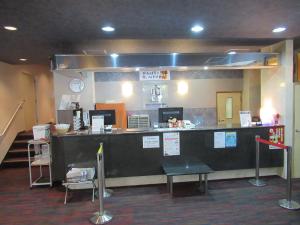 a lobby with a large counter with a counter sidx sidx sidx at Hotel Crown Hills Kumamoto in Kumamoto