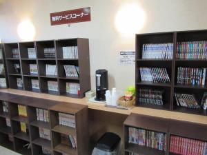 a library with several shelves filled with dvds at Hotel Crown Hills Kumamoto in Kumamoto