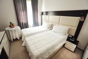 Postel nebo postele na pokoji v ubytování Hotel Vila e Arte City Center