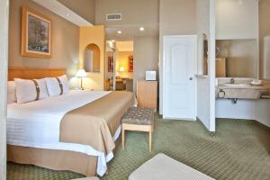 a hotel room with a large bed and a bathroom at Holiday Inn Cuernavaca, an IHG Hotel in Cuernavaca