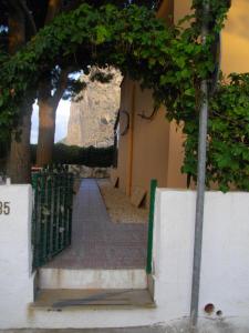 an entrance to a building with an arch with trees at Villa I Due Pini in San Vito lo Capo
