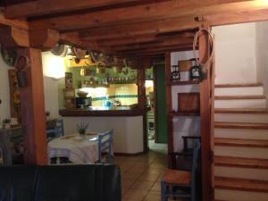 a kitchen and dining room with a table and a counter at La Grange in Durban-Corbières