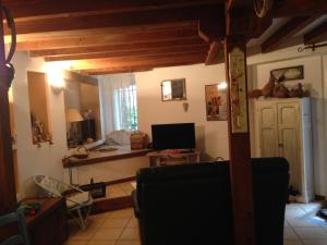 un soggiorno con un divano e una televisione di La Grange a Durban-Corbières Altre 24 foto