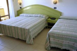 Postel nebo postele na pokoji v ubytování Hotel Rivadoro-Spiaggia ombrellone e lettini-Piscina-Parcheggio