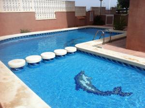 a swimming pool with a shark in the water at Apartamentos Arenales Del Sol III in Arenales del Sol