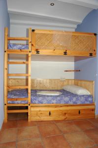 two bunk beds in a room with a bed at Casa Cami Real in Villafranca del Cid