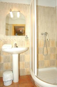 a bathroom with a sink and a shower with a mirror at Casa Cami Real in Villafranca del Cid +27 photos