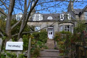 a house with a sign that reads the simple at The Spindle Guest Rooms in St. Andrews