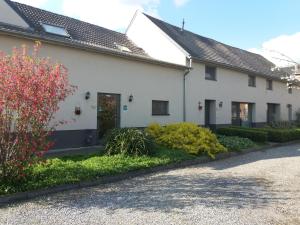 a white house with a garden in front of it at De Aventurijn in Riemst
