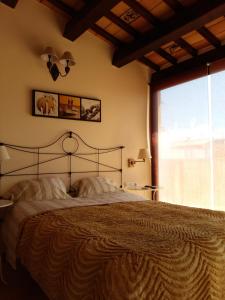 a bedroom with a large bed with a large window at Pensió Rosa Dels Vents in Perelló