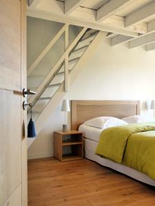 a bedroom with a bed and a wooden floor at La Bastide in Lamillarié