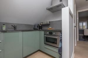 Kuchyň nebo kuchyňský kout v ubytování De Herberg Appartementen