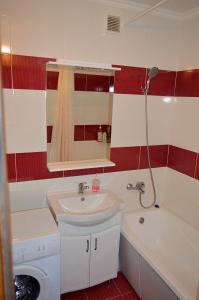 a bathroom with a sink and a bath tub at Central Park Apartment on Pushkin 33 in Chişinău