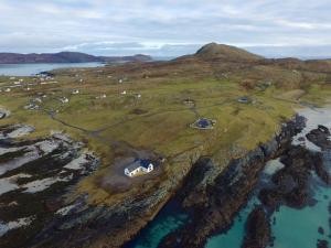 an aerial view of an island with animals on a hill at An Taigh Mòr in Eriskay