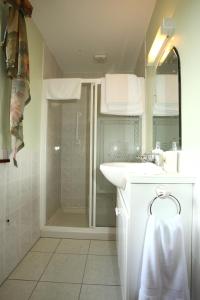 a bathroom with a shower and a sink and a mirror at Doogarry House B&B in Castlebar