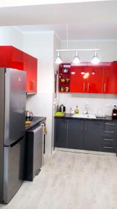 アテネにあるCentral Cozy Flatのキッチン(赤いキャビネット、黒い冷蔵庫付)