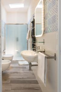 a bathroom with two sinks and a mirror at La Dimora sull'Arco in Monopoli