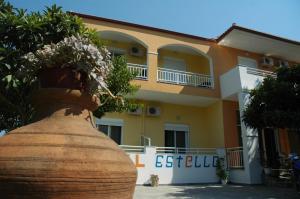 a building with a large vase in front of it at Estelle Hotel in Gerakini