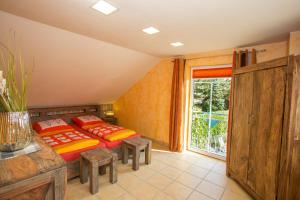 a bedroom with two beds and a large window at Wildnisresidenz am Nationalpark in Lindberg