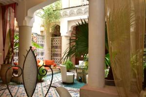 a hotel lobby with a surfboard in a room at Riad Manissa in Marrakesh