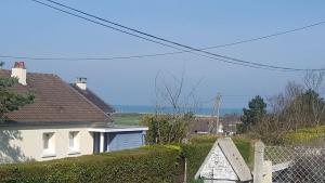 a white house with a fence in front of it at La Crielloise in Criel-sur-Mer