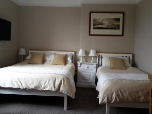 A bed or beds in a room at The Breverton