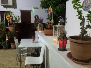 a white table with chairs and potted plants on it at Villa Elena in Líndos