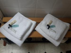 two white towels sitting on top of a wooden bench at The Breverton in Lytham St Annes