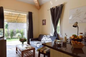 a living room with a couch and a table at Les Maisons Du Sud in Saint-Tropez
