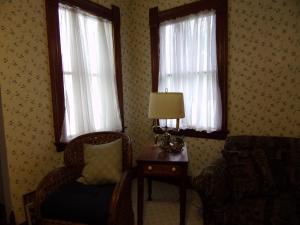 a room with two windows and a chair and a lamp at Country Diamond in Sidney