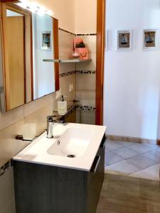 a bathroom with a sink and a mirror at Casa MareLuna in San Vito lo Capo
