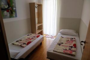 Postel nebo postele na pokoji v ubytování Apartments Kovacic
