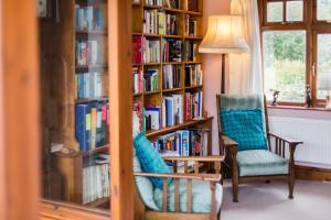 a room with a book shelf filled with books at Ael y Bryn Luxury B&B, North Pembrokeshire in Eglwyswrw