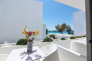 a dining room with a table and chairs and a view of the ocean at Thomais Studios in Naxos Chora