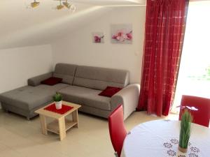 a living room with a couch and a table at Apartments Brčić in Kaštela