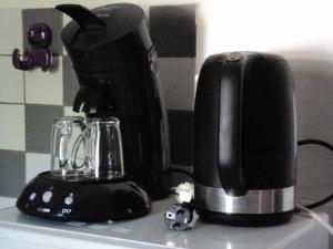 a black coffee maker sitting on top of a counter at La Douloire in Pernes-les-Fontaines