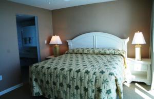 a bedroom with a large bed and two lamps at Club Regency at Regency Towers in Myrtle Beach