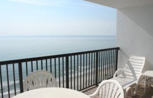 a balcony overlooking the ocean with a view of the beach at Club Regency at Regency Towers in Myrtle Beach