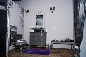 a room with a dresser and a chair and a mirror at Chambre d'Hôtes La Marlotte in Castello-di-Rostino +114 photos