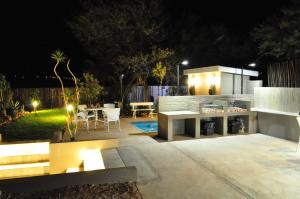 a patio at night with a table and chairs at The Calitz in Calitzdorp