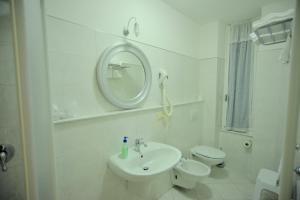 a bathroom with a sink and a toilet and a mirror at Affittacamere Agata in Levanto