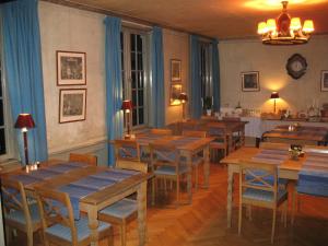 a dining room with wooden tables and chairs at Forsbacka Wärdshus in Forsbacka