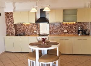a kitchen with a table and stools in it at Voyage Residence in Mamaia