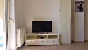 a television sitting on a white cabinet in a room at Voyage Residence in Mamaia