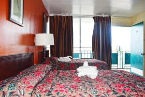 a hotel room with a bed with red walls at Skyview Manor Motel in Seaside Heights