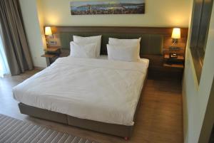 Postel nebo postele na pokoji v ubytování Numi Hotel