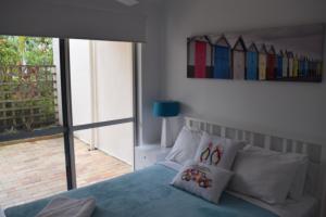 a bedroom with a bed and a window at Raintrees Resort in Caloundra