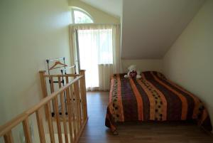 a bedroom with a bed with a teddy bear on it at PribaltDom in Jūrmala