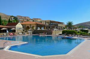 a large pool with blue water in a resort at Lemnos Village Resort Hotel in Platy